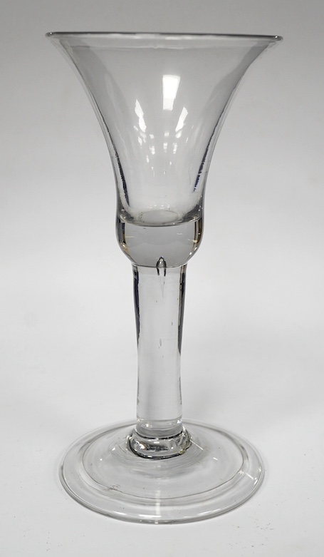 A heavy plain stem wine glass, circa 1740, bell shaped bowl, folded foot, 18cm high. Condition - good